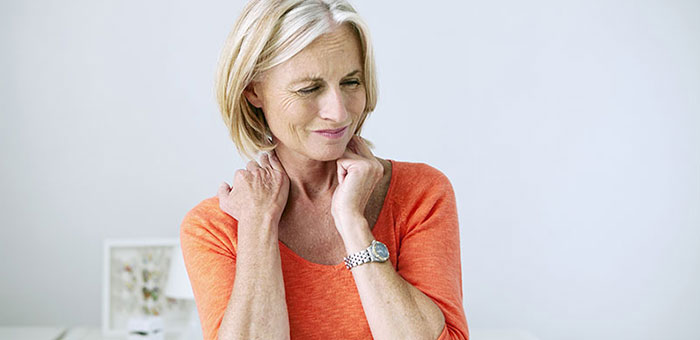 Mature woman suffering from neck and shoulder pain before visiting Denver chiropractor