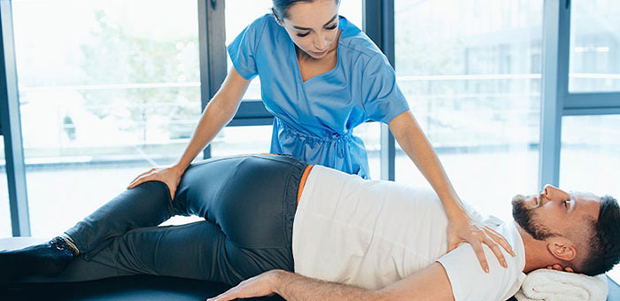 Patient receiving sciatica treatment from Denver chiropractor