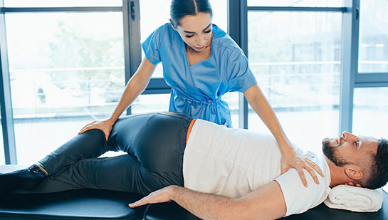 Patient receiving sciatica treatment from Denver chiropractor