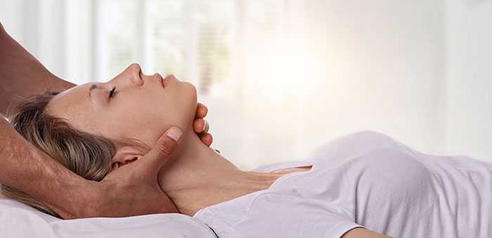 Woman receiving neck adjustment from Denver chiropractor