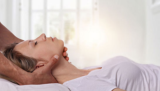 Woman receiving neck adjustment from Denver chiropractor