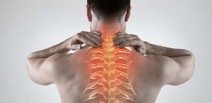 Man with upper back pain before chiropractic treatment from Denver chiropractor