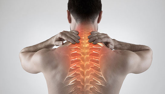Man with upper back pain before chiropractic treatment from Denver chiropractor